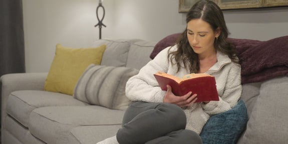 abby brooks on couch with bible