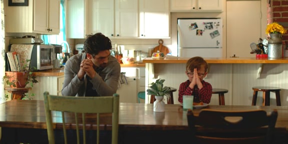 father and son praying at kitchen table god's country song