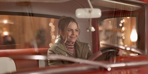 candace cameron bure in red truck in a christmas less traveled