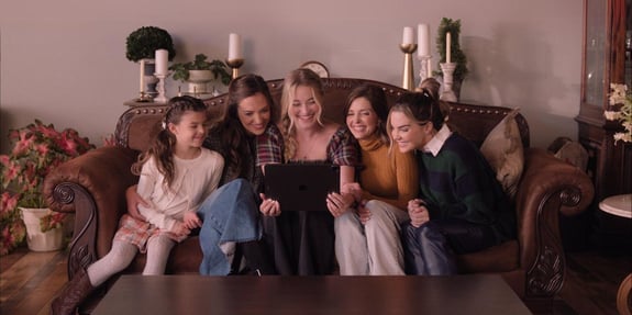 family gathered on couch a little women's christmas