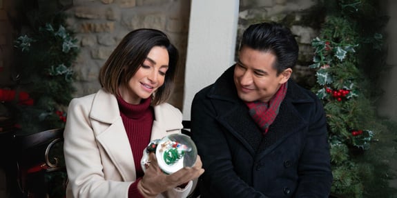 mario and courtney lopez with snow globe once upon a christmas wish