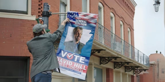 hanging up voting banner in God's not Dead in God We Trust